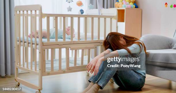 mom has postpartum depression - moms crying in bed stock pictures, royalty-free photos & images