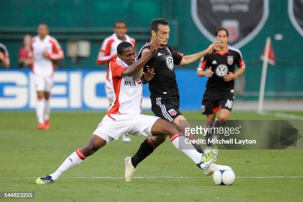 Hamdi Salihi of D.C. United controls the ball against Donell Henry of Toronto FC at RFK Stadium on May 19, 2012 in Washington, DC.