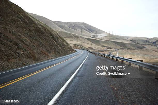 roadside along empty highway - crash barrier stock pictures, royalty-free photos & images