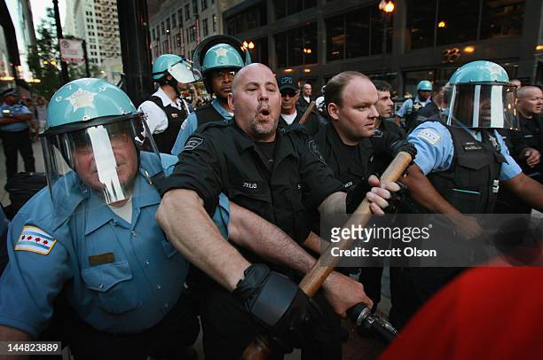 Police try to keep demonstrators from breaking through their lines durijng a march through the downtown streets on May 19, 2012 in Chicago, Illinois....