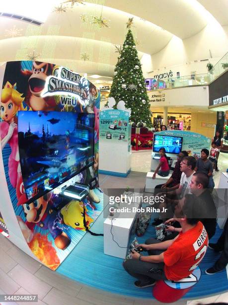 Video gamers take a break from holiday shopping to play Nintendo video games at Westfield Shopping Mall, November 24, 2014 in Culver City, California.