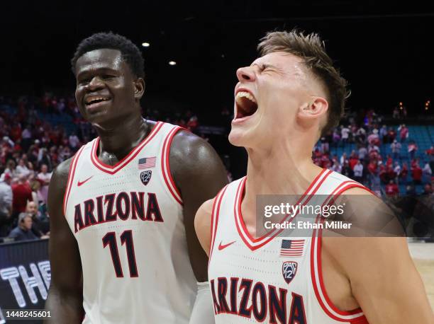 Oumar Ballo and Pelle Larsson of the Arizona Wildcats celebrate as they walk off the court after the team's 89-75 victory over the Indiana Hoosiers...