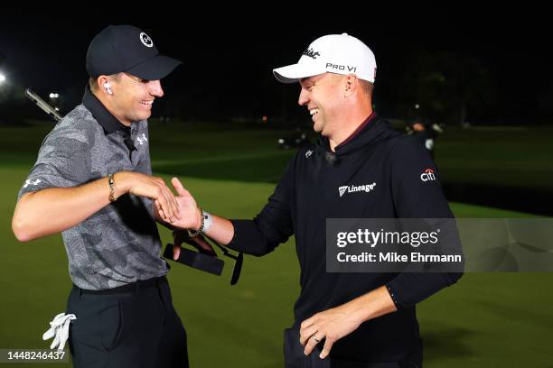 Jordan Spieth of the United States and Justin Thomas of the United States celebrate with their bracelets after defeating Tiger Woods of the United...
