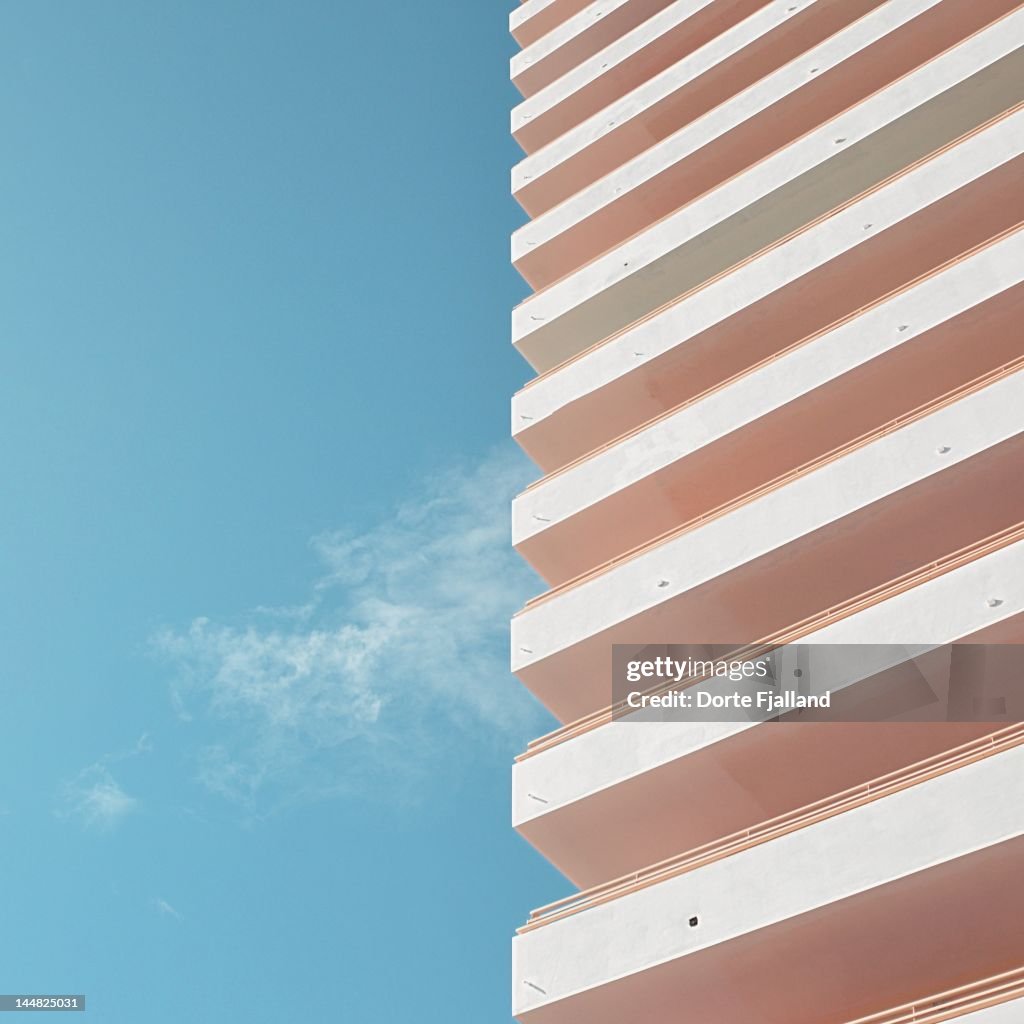 Blue sky, thin white cloud and white building