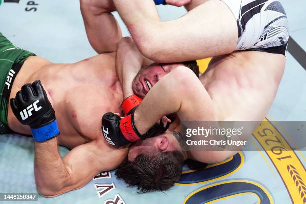 Darren Till of England attempts to submit Dricus Du Plessis of South Africa in a middleweight fight during the UFC 282 event at T-Mobile Arena on...