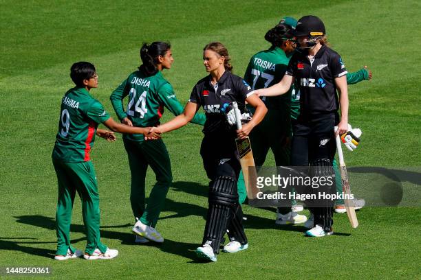 Suzie Bates and Maddy Green of New Zealand shake hands with Fahima Khatun and Disha Biswas of Bangladesh during the first One Day International match...