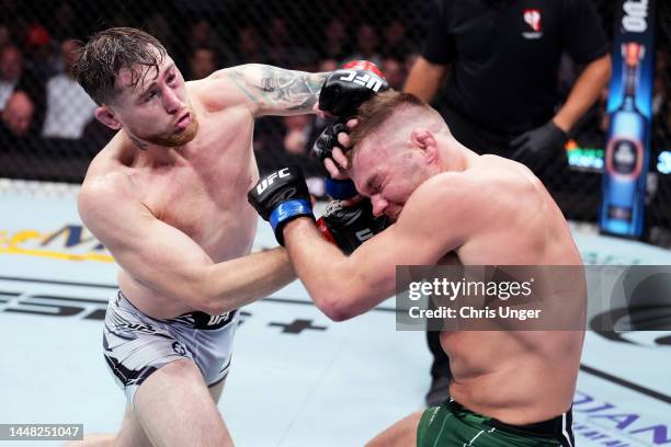 Darren Till of England punches Dricus Du Plessis of South Africa in a middleweight fight during the UFC 282 event at T-Mobile Arena on December 10,...