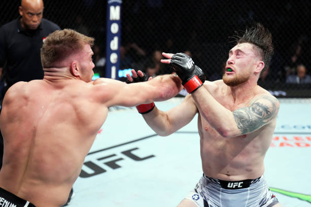 Dricus Du Plessis of South Africa punches Darren Till of England in a middleweight fight during the UFC 282 event at T-Mobile Arena on December 10,...