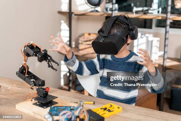 pleasant smart boy testing vr glasses at home - vr goggles business stockfoto's en -beelden