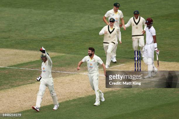 Michael Neser of Australia celebrates with Alex Carey after taking the wicket of Roston Chase of the West Indies during day four of the Second Test...