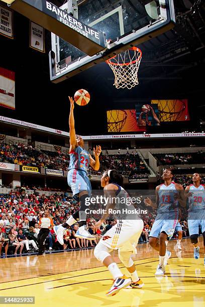 Armintie Price of the Atlanta Dream goes for a layup against Briann January of the Indiana Fever at Bankers Life Fieldhouse on May 19, 2012 in...