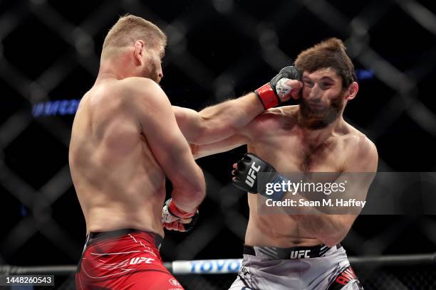 Jan Blachowicz of Poland punches Magomed Ankalaev of Russia in their UFC light heavyweight championship fight during the UFC 282 event at T-Mobile...