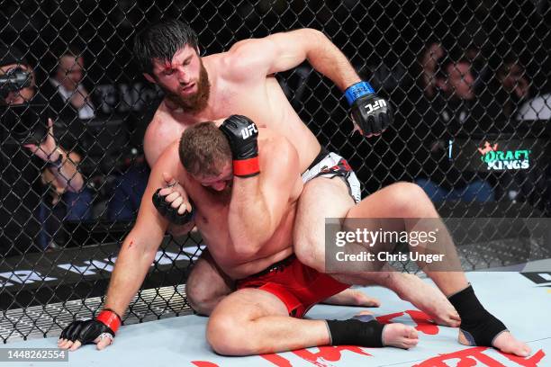Magomed Ankalaev of Russia controls the body of \jb1 in their UFC light heavyweight championship fight during the UFC 282 event at T-Mobile Arena on...