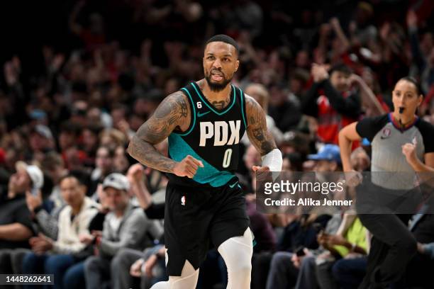 Damian Lillard of the Portland Trail Blazers reacts to making a three point basket during the fourth quarter against the Minnesota Timberwolves at...