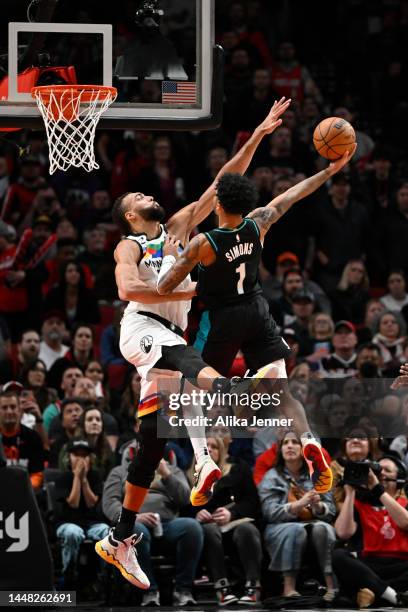 Anfernee Simons of the Portland Trail Blazers shoots against Rudy Gobert of the Minnesota Timberwolves during the fourth quarter at the Moda Center...