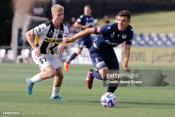 Jed Drew of the Bulls and Kadete of the Victory run with the ball during the round seven A-League Men's match between Macarthur FC and Melbourne...