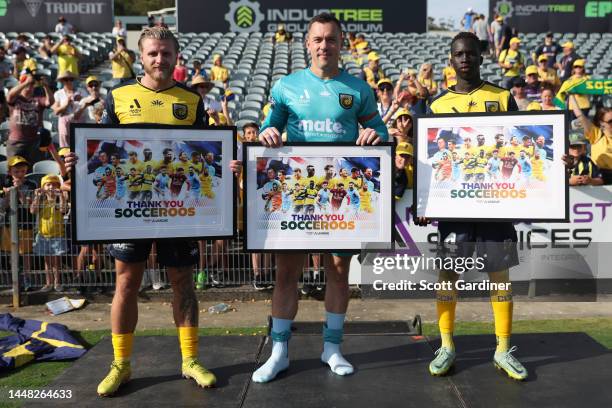 Jason Cummings, Danny Vukovic, and Grang Kuol of the Mariners receive thank you awards for the participation in 2022 Socceroos World Cup team the...