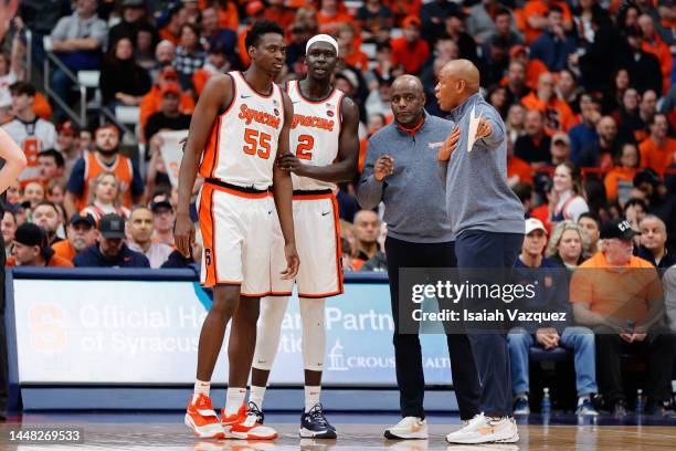 Mounir Hima of the Syracuse Orange and John Bol Ajak of the Syracuse Orange talk to Adrian Autry and Allen Griffin assistant coaches of the Syracuse...