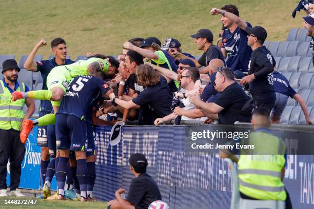 Victory celebrate a goal with fans during the round seven A-League Men's match between Macarthur FC and Melbourne Victory at Campbelltown Stadium, on...