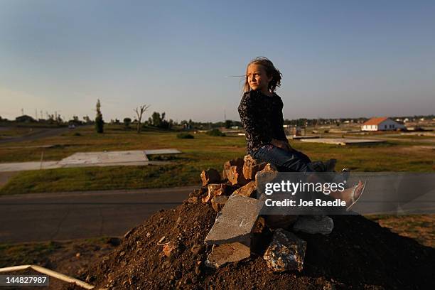 Camryn Dean plays on a pile of dirt behind her mother's rebuilt home in the heart of what was once nothing but debris and destroyed homes after a...