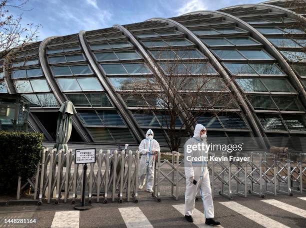 Security wear PPE to protect against the spread of COVID-19 as they guard outside an office building on December 11, 2022 in Beijing, China. As part...