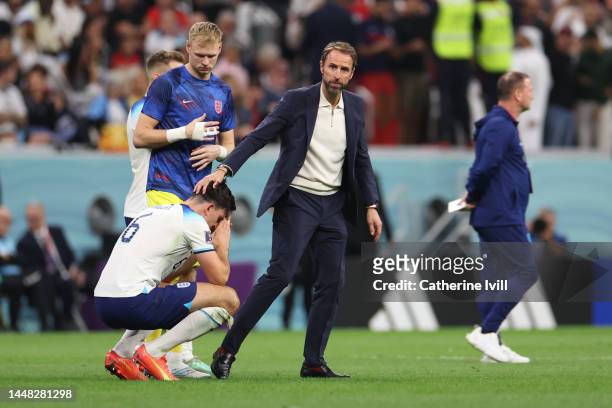 Gareth Southgate, Head Coach of England consoles Harry Maguire of England following the FIFA World Cup Qatar 2022 quarter final match between England...