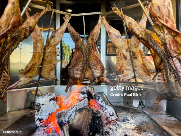 lamb of patagonia slowly roasted over the fire, typical dish of chile and argentina. lamb to the post. cordero al palo - argentina traditional food stock pictures, royalty-free photos & images