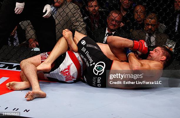 Josh Thomson attempts to submit Gilbert Melendez during the Strikeforce event at HP Pavilion on May 19, 2012 in San Jose, California.