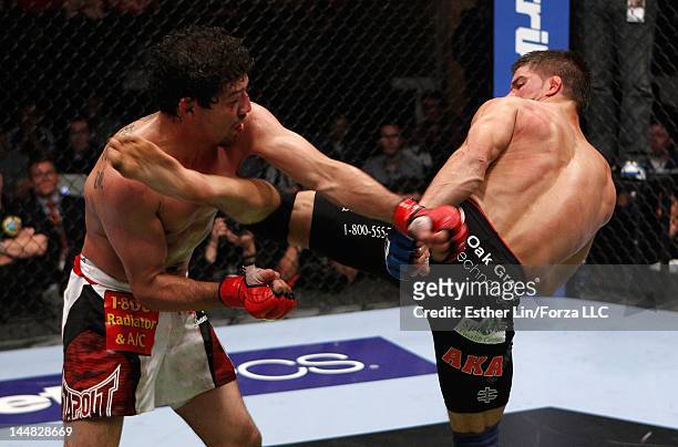Josh Thomson kicks Gilbert Melendez during the Strikeforce event at HP Pavilion on May 19, 2012 in San Jose, California.