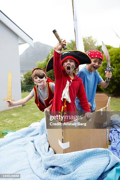 boys playing pirates together - pirata stock-fotos und bilder