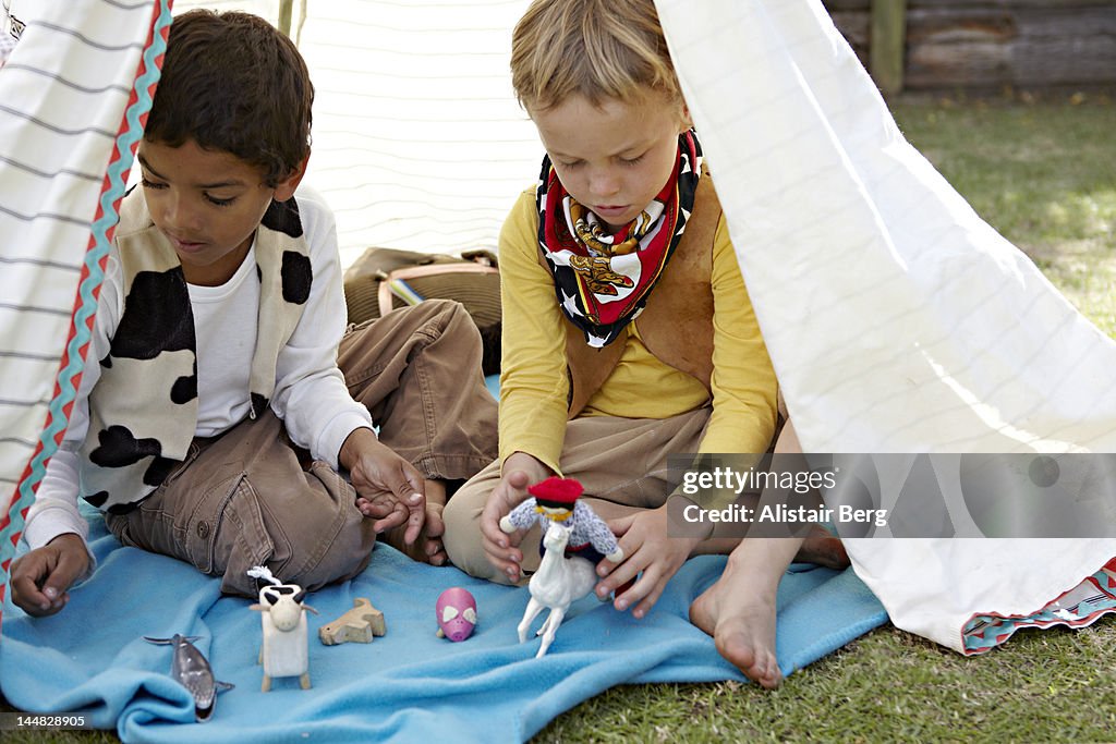 Two boys playing in a tent