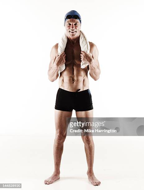 full body portrait of mature male swimmer - badehose stock-fotos und bilder