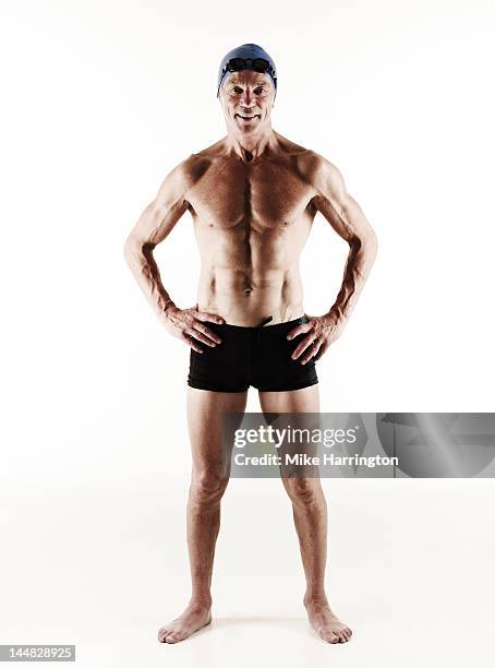 full body portrait of mature male swimmer - man standing full body stock-fotos und bilder