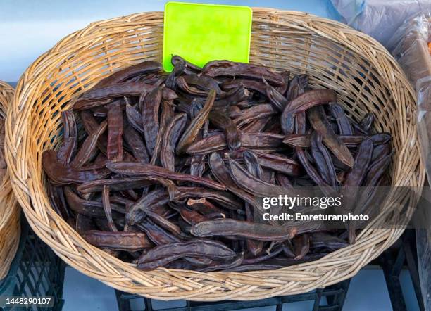 high angle view of locust beans in a basket. - locust stock pictures, royalty-free photos & images