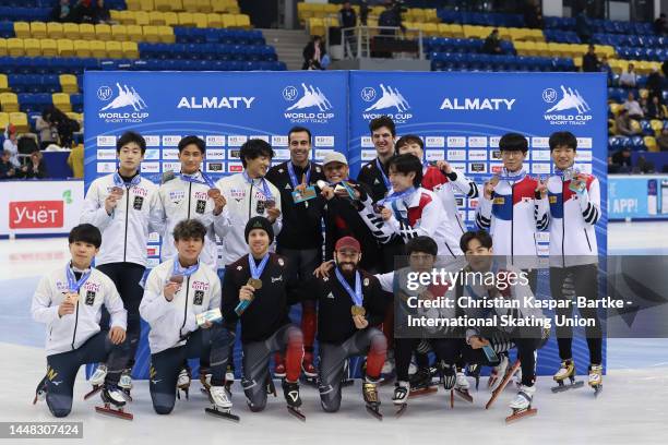 Team Japan, Team Canada and Team Korea pose on podium after medal ceremony in Men's 5000m Team Relay Final race during the ISU World Cup Short Track...