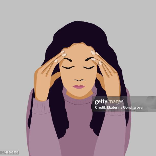 a young girl is sitting on the couch at home with her head in her hands. illustration - pain face stock-fotos und bilder