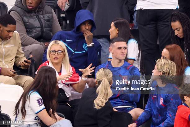 Phil Foden with partner Rebecca Cooke, above Marcus Rashford and girlfriend Lucia Loi following the FIFA World Cup Qatar 2022 quarter final match...