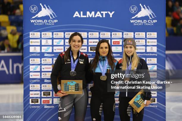 Courtney Sarault of Canada, Hanne Desmet of Belgium and Anna Seidel of Germany pose on podium after medal ceremony of Women's 1500m Final A race...