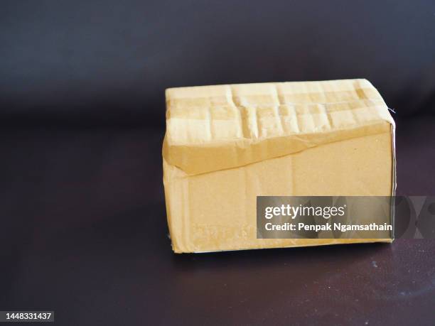 brown carton box on mirror table - mirror paper texture stock pictures, royalty-free photos & images