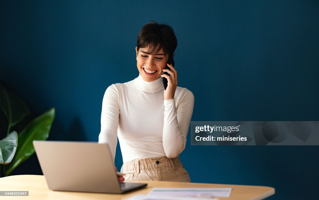 Portrait of a Beautiful Businesswoman Talking on the Phone and Working