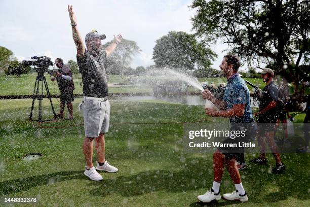 Ockie Strydom of South Africa being sprayed champagne by Erik Van Rooyen of South Africa after winning the Alfred Dunhill Championship on the 18th...