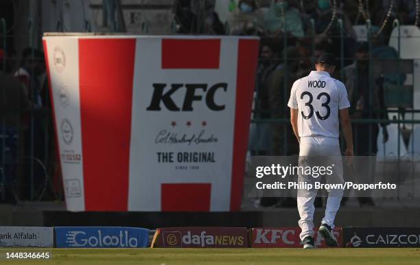 Mark Wood in the field near a large bucket promoting KFC during the third day of the second Test between Pakistan and England at Multan Cricket...
