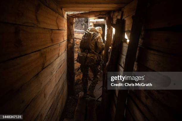 Member of the Ukrainian military moves through a trench system at a position on the outskirts of Donetsk on December 11, 2022 in Donetsk, Ukraine. A...