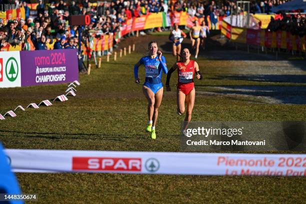 Gaia Sabbatini of Italy and Rosalia Tarraga of Spain compete in Mixed Relay during the SPAR European Cross Country Championships at Piemonte-La...