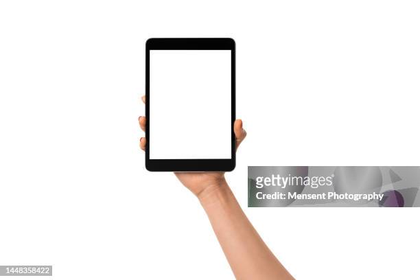 woman hand holding modern digital tablet mockup with white screen on white background - tablet halten stock-fotos und bilder
