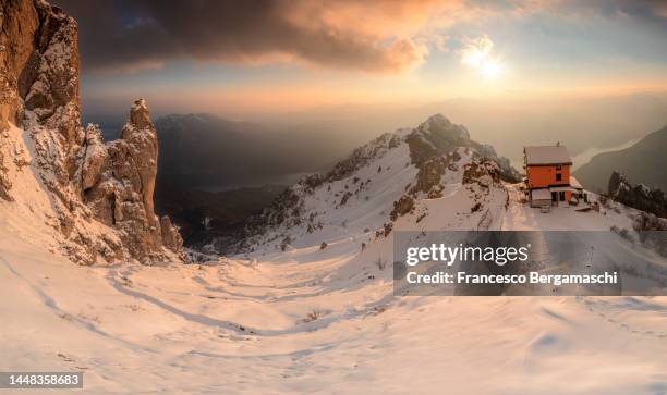 panoramic view of rifugio rosalba  in winter at sunset. - howse peak stock pictures, royalty-free photos & images