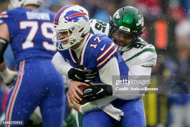 Quinnen Williams of the New York Jets sacks Josh Allen of the Buffalo Bills in the first quarter at Highmark Stadium on December 11, 2022 in Orchard...