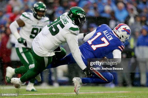 Quinnen Williams of the New York Jets sacks Josh Allen of the Buffalo Bills in the first quarter at Highmark Stadium on December 11, 2022 in Orchard...