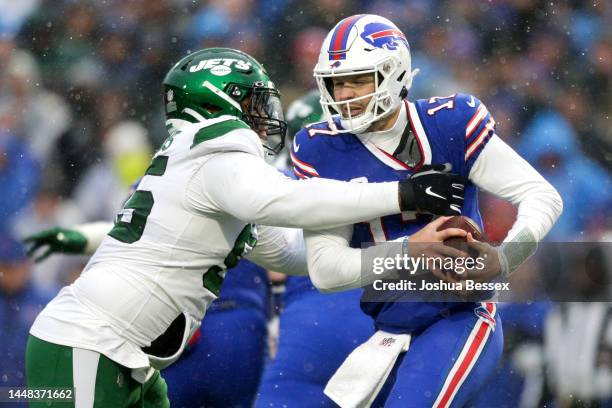 Quinnen Williams of the New York Jets looks to tackle Josh Allen of the Buffalo Bills in the first quarter at Highmark Stadium on December 11, 2022...