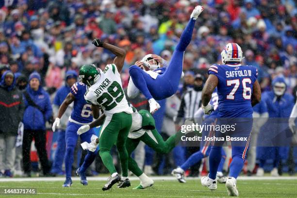 Josh Allen of the Buffalo Bills is upended after hurdling Lamarcus Joyner of the New York Jets in the second quarter at Highmark Stadium on December...